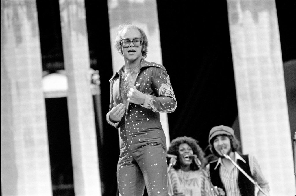 Detail of Elton John performing on stage at Wembley Stadium., London, England in June 1975 by Chris Barham