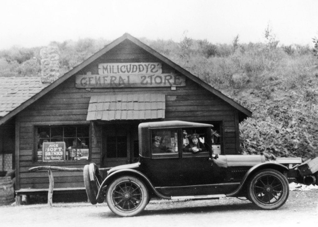 Detail of 1916 Cadillac V8 car, parked outside a general store, USA, (c1916?) by Unknown