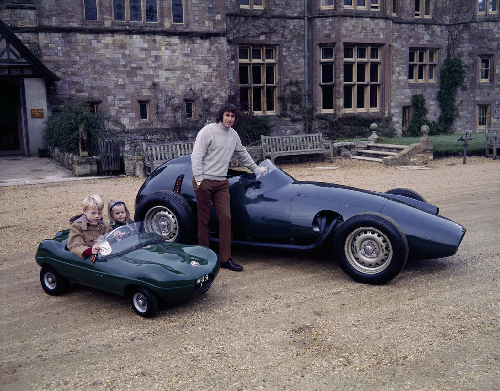 Detail of Jackie Stewart posing with a 1957 BRM by Unknown