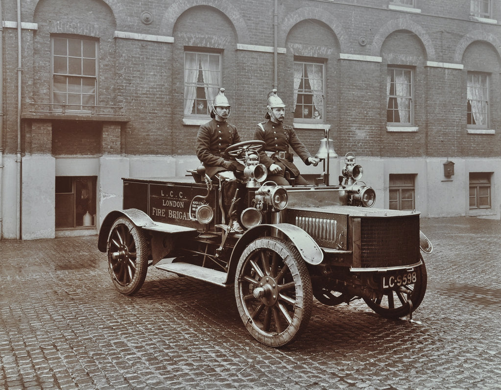 Detail of Firemen in brass helmets aboard a motor hose tender, London Fire Brigade Headquarters, London, 1909 by Unknown