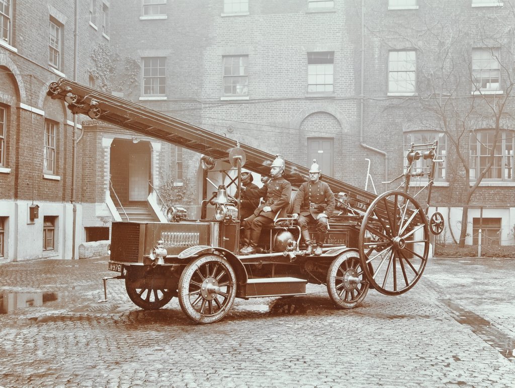 Detail of Firemen aboard a motor fire escape vehicle, London Fire Brigade Headquarters, London, 1909 by Unknown