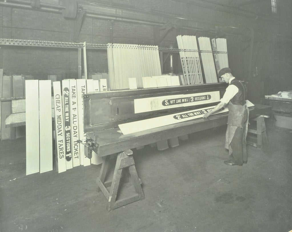 Detail of Man stencilling signs for tram cars at Charlton Central Repair Depot, London, 1932 by Unknown