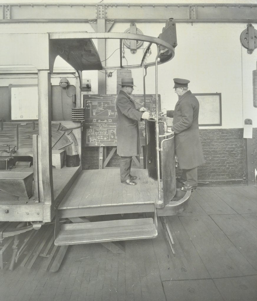 Detail of Learner-driver under instruction in a mock-up of tram car cab, London, 1932 by Unknown