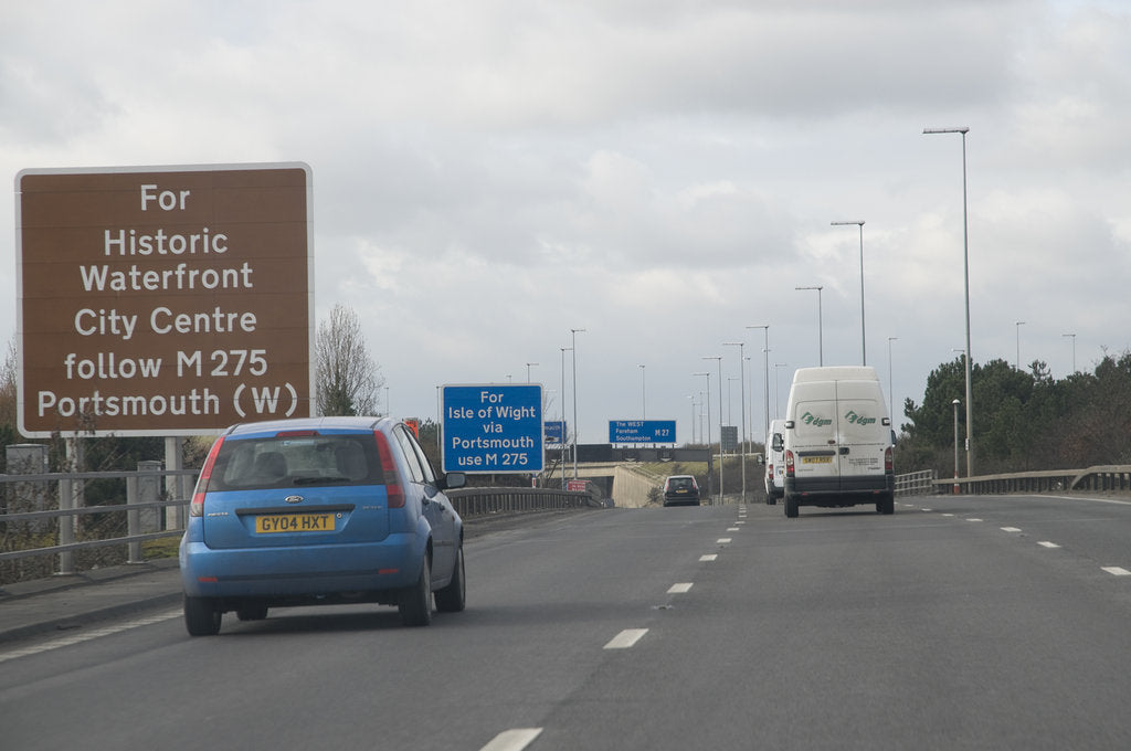 Detail of Traffic on M27 Motorway with brown tourist information sign by Anonymous