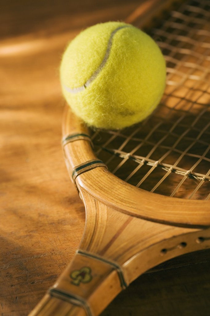 Detail of Tennis Ball and Wood Racket by Corbis