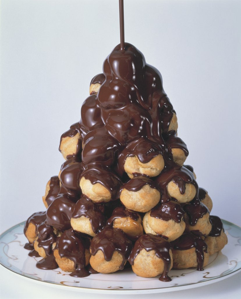 Detail of Pyramid of Chocolate Drizzled Cream Puffs by Corbis