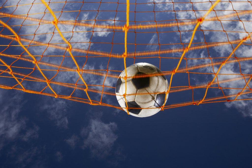 Detail of Soccer Ball Going Into Goal Net by Corbis