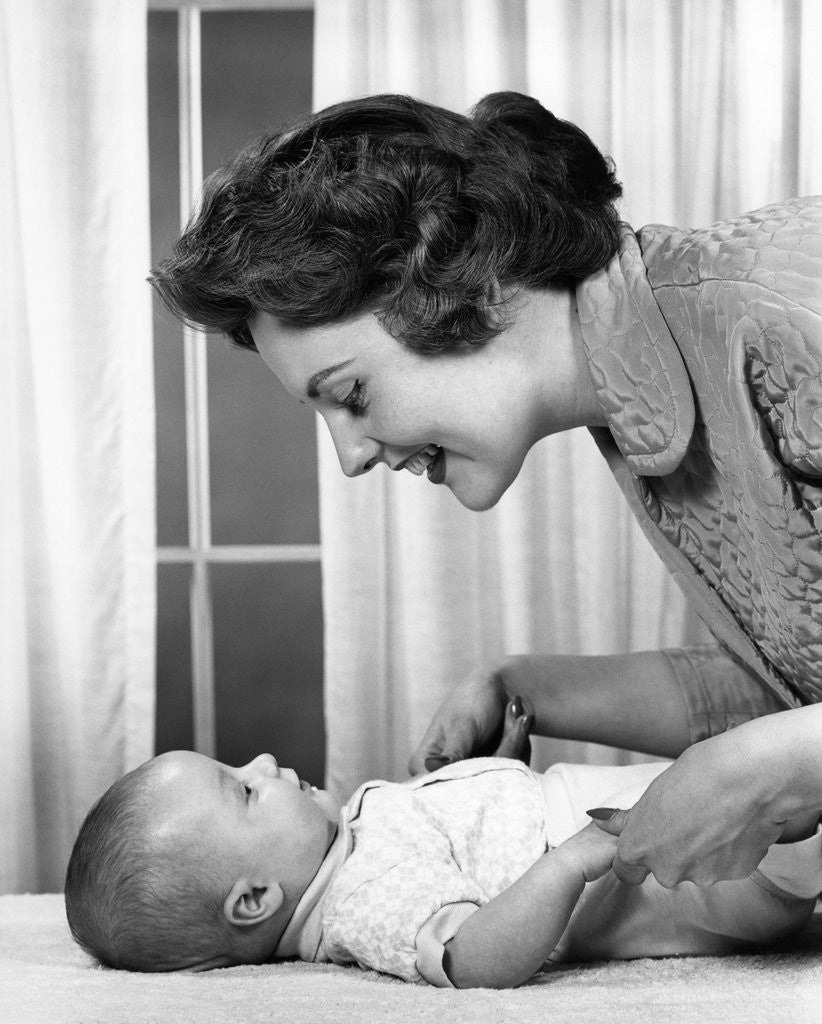 Detail of 1950s 1960s Mother At Baby Lying On Table Indoor by Corbis