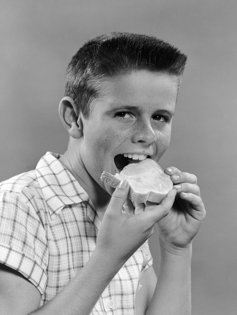 Detail of 1950s Boy With Crew Cut Eating A Slice Of Bread by Corbis