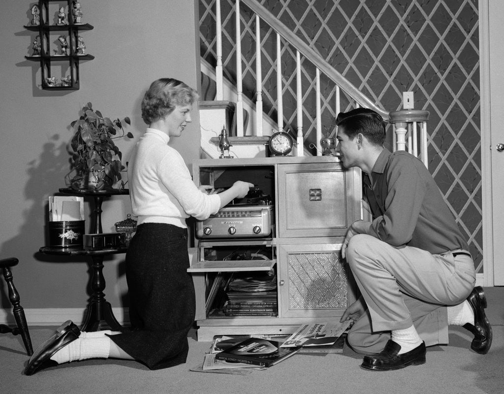 Detail of 1950s Teenage Couple Playing Hi-Fi Records On Console Phonograph In Living Room by Corbis