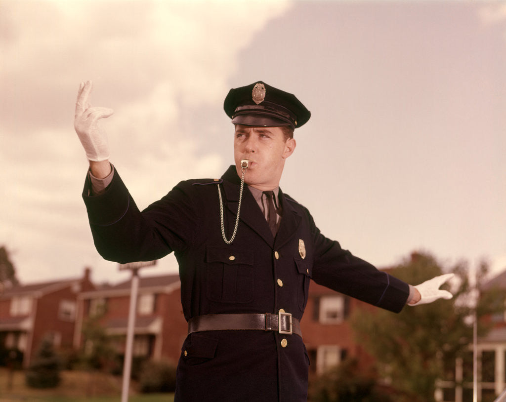 Detail of 1960s Man Policeman Blowing Whistle Directing Traffic by Corbis