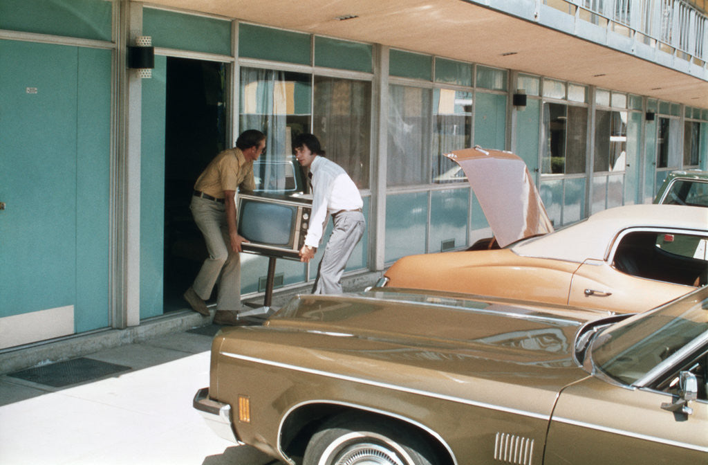 Detail of 1970s Two Men Stealing Televsion Set From Motel Room by Corbis