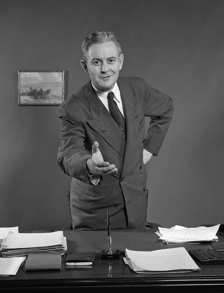 Detail of 1950s Man Businessman Salesman Reaching Across Desk To Shake Hands by Corbis