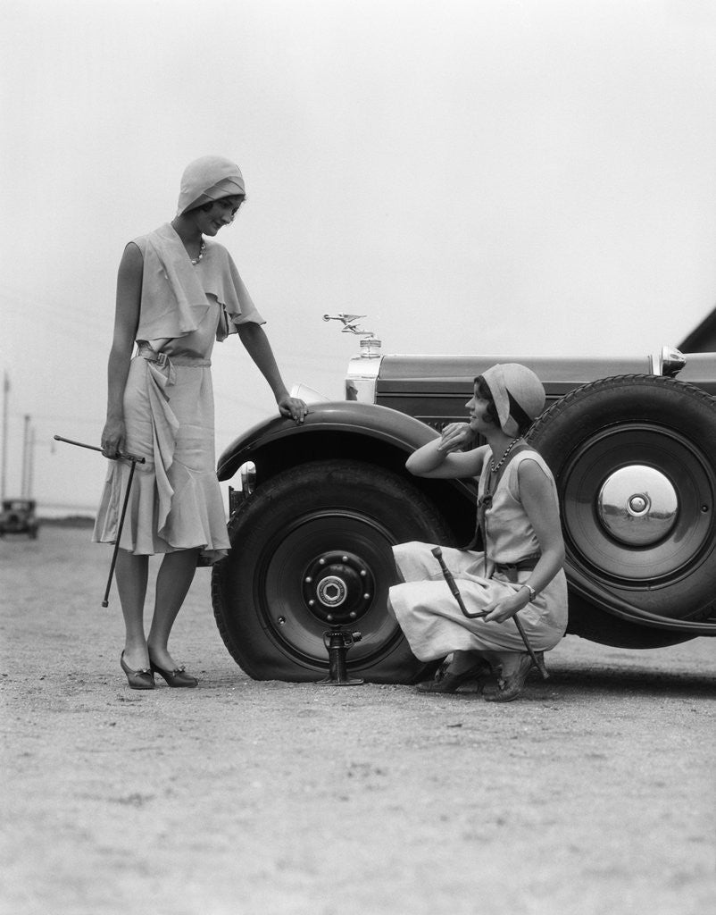 Detail of 1930s Two Women Confront An Automobile Flat Tire by Corbis