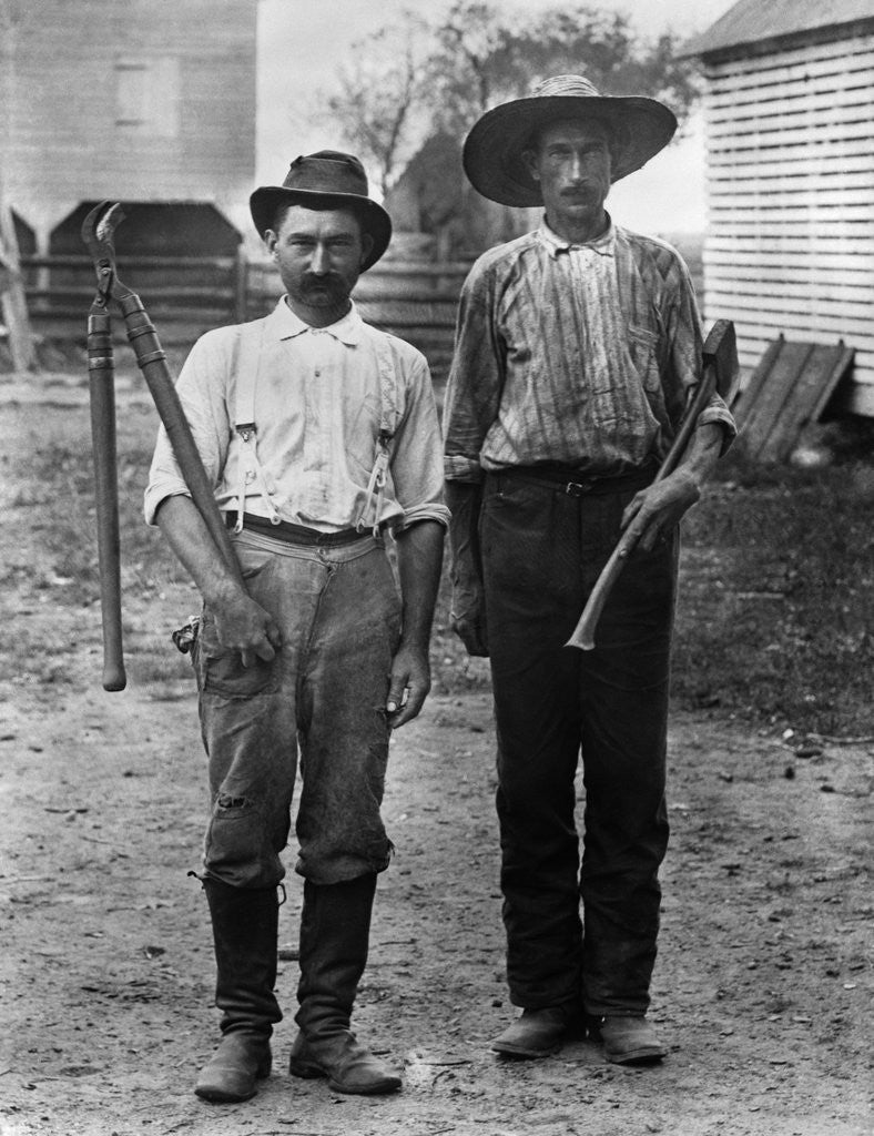 Detail of 1890s 1900s 2 Men On Farm In Work Clothes One Holding Pruner and One Holding Ax by Corbis