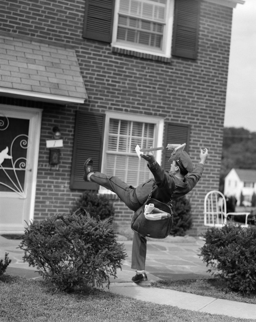 Detail of 1950s Man Mailman Tripping Falling In Front Of A Suburban Brick House Accident by Corbis