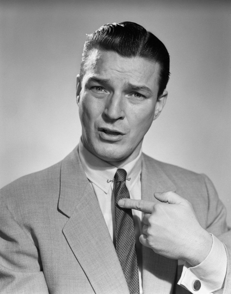 Detail of 1950s Businessman Serious Expression Pointing To His Chest Confused by Corbis