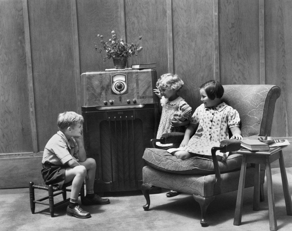 Detail of 1930s Two Little Girls And A Boy Sitting In Living Room Listening To Radio by Corbis