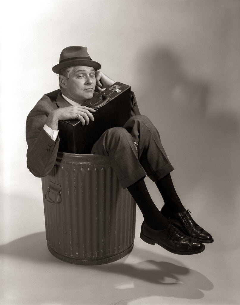 Detail of 1960s Fired Businessman Sitting In Trash Can by Corbis