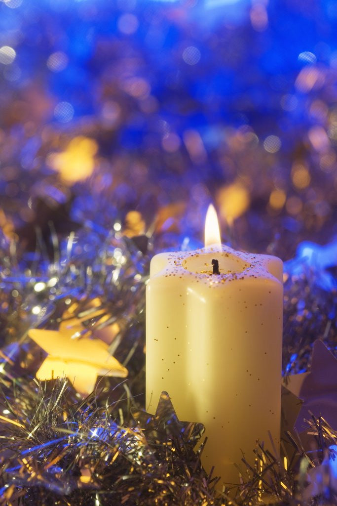 Detail of Lighted candle arrangement surrounded by holiday decorations by Corbis