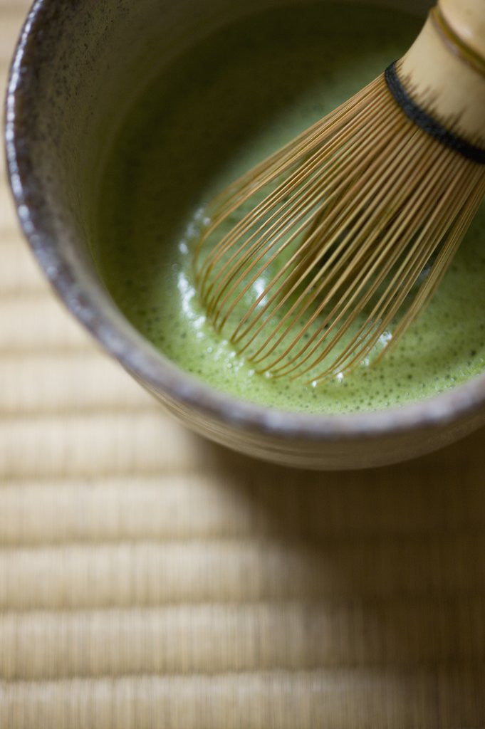 Detail of Japanese tea bowl and bamboo whisk by Corbis