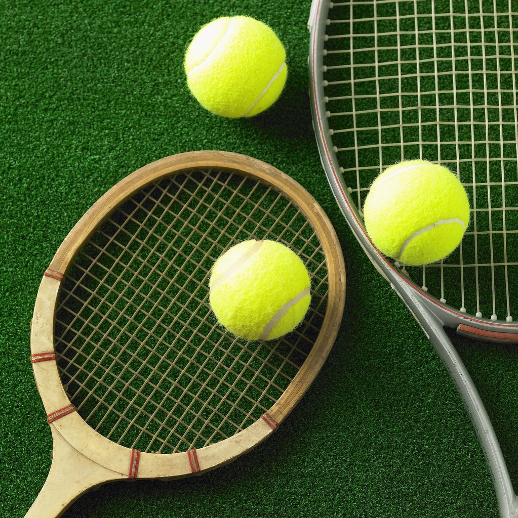 Detail of Tennis racket and tennis ball by Corbis