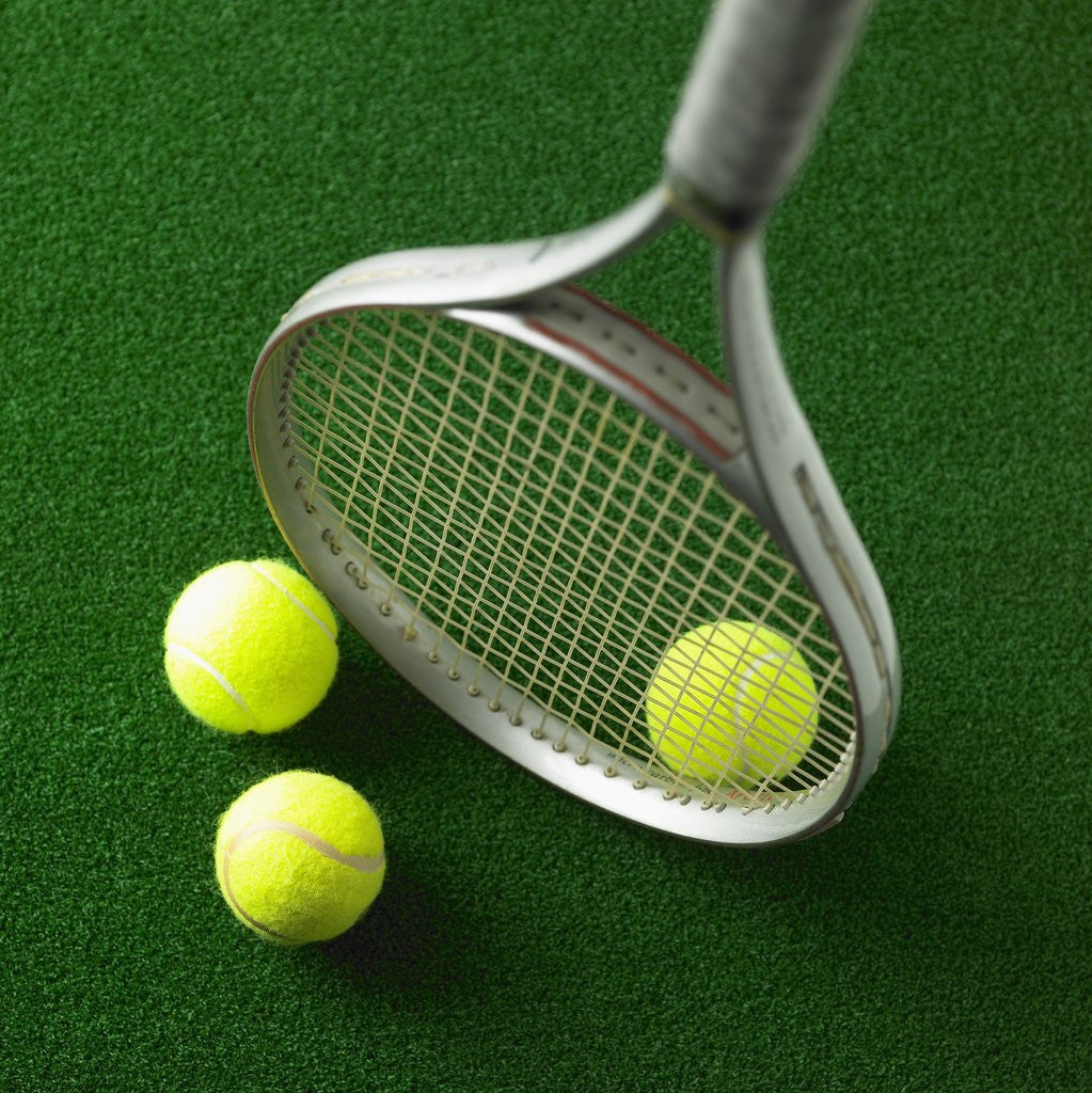 Detail of Tennis racket and tennis ball by Corbis