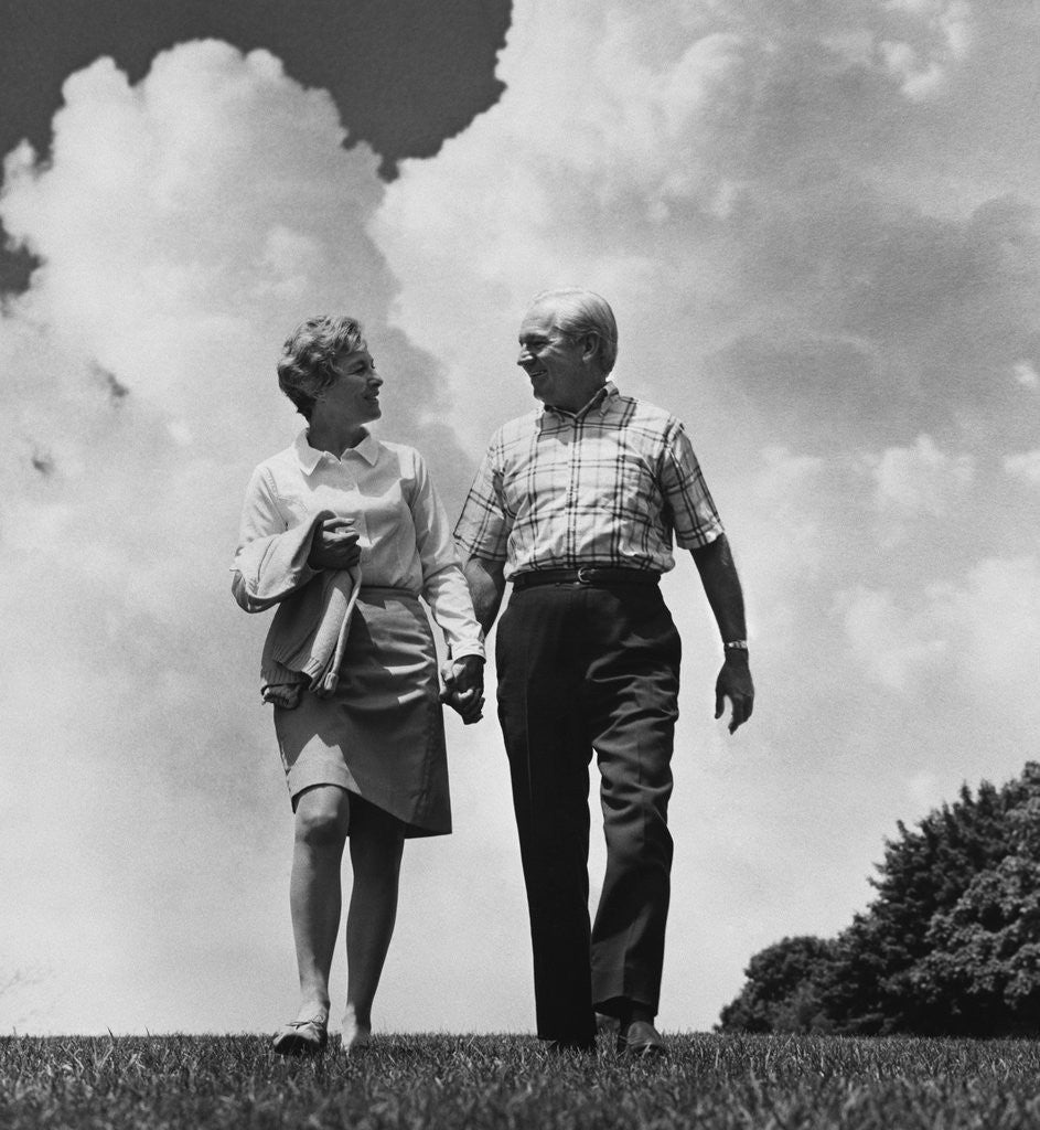 Detail of Mature couple walking holding hands by Corbis