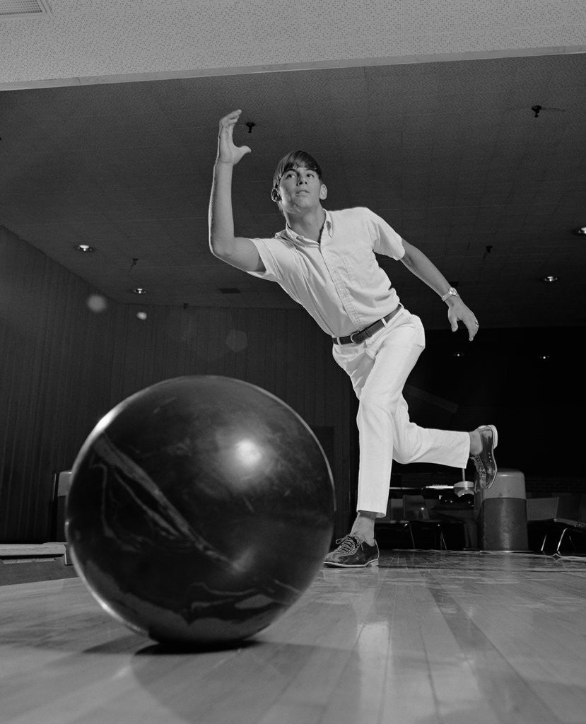 Detail of Young man having just thrown a bowling ball by Corbis