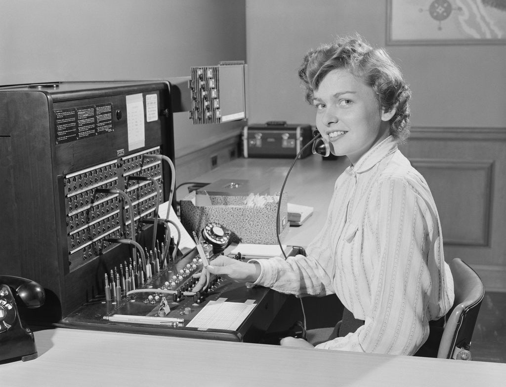 Detail of Smiling woman office telephone switchboard operator by Corbis