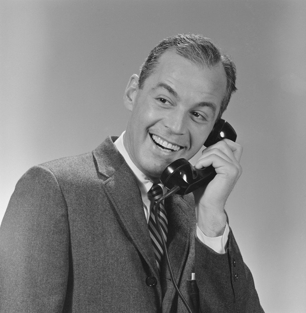 Detail of Smiling business man telephone conversation by Corbis