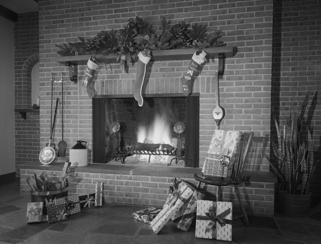 Detail of Stockings hung by fireplace and wrapped christmas presents by Corbis