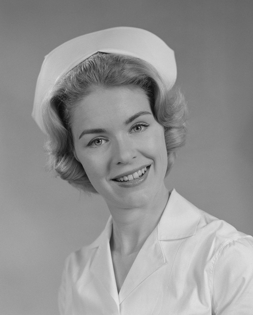 Detail of Female nurse smiling by Corbis