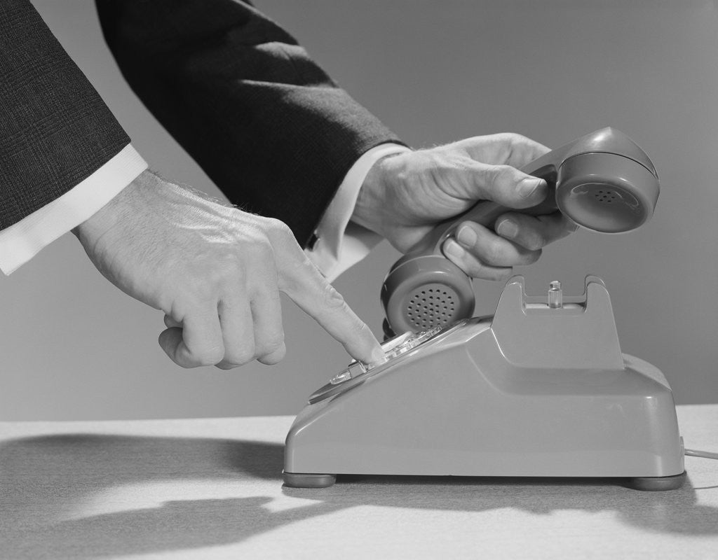 Detail of Male hands dialing rotary telephone by Corbis