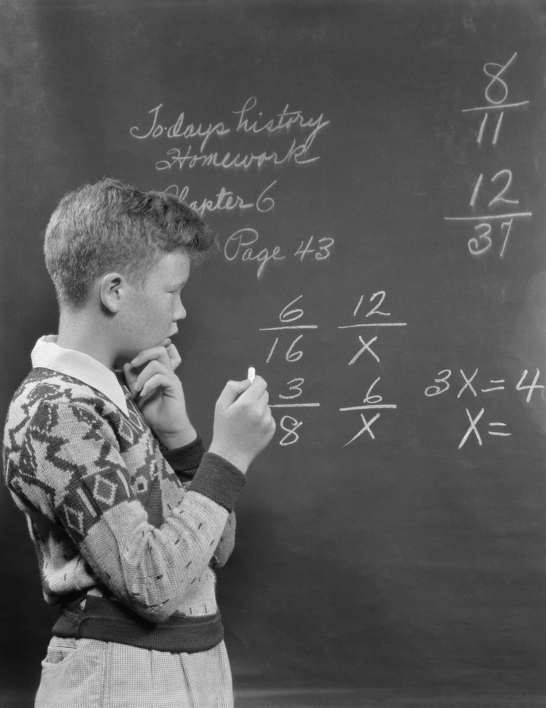 Detail of Boy at blackboard doing math multiplication problem by Corbis