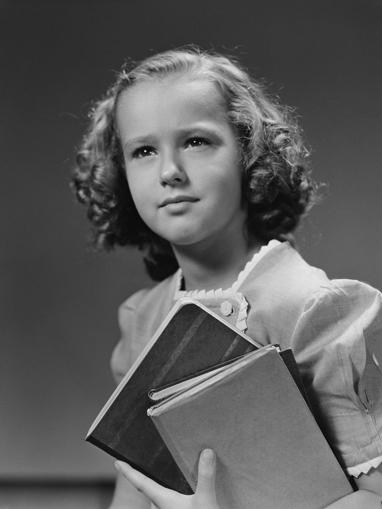 Detail of Portrait serious girl student holding school books by Corbis