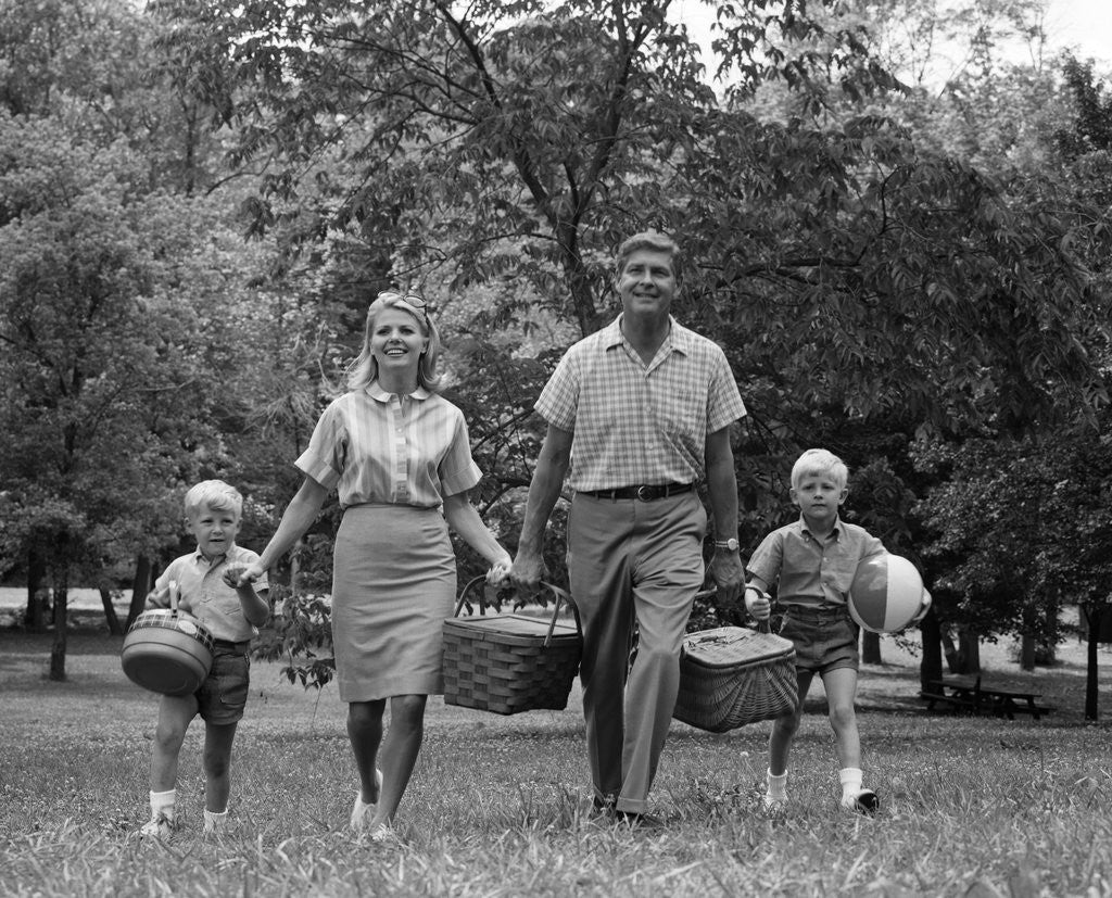 Detail of 1960s family picnic walking toward looking at camera by Corbis