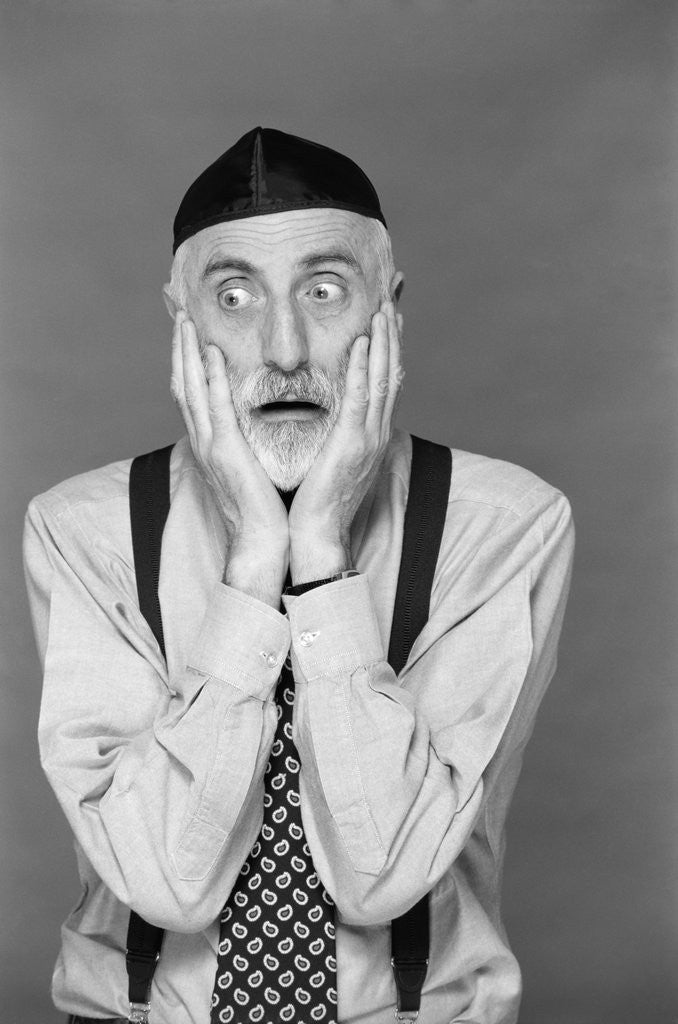 Detail of 1990s portrait jewish man gray beard wearing yarmulke both hands on face funny expression oy vey shock fear worry despair by Corbis