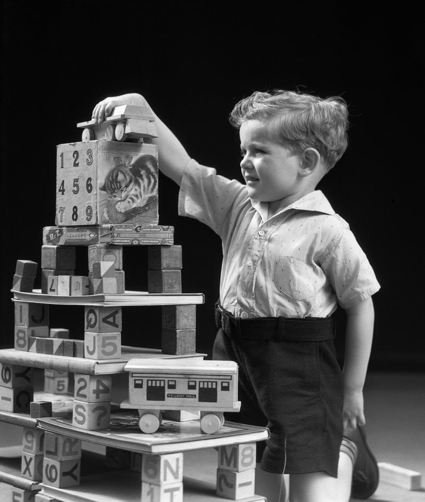 Detail of 1930s boy playing with toys and building blocks by Corbis