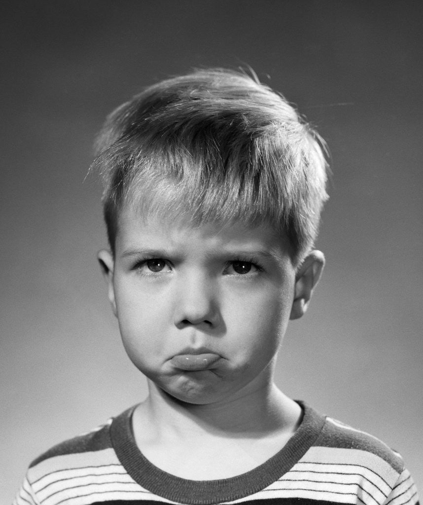 Detail of 1950s portrait blond boy sad grumpy angry pouting facial expression looking at camera by Corbis