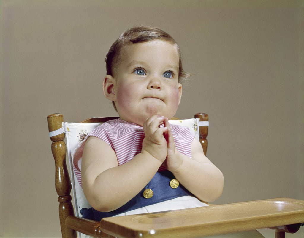 Detail of 1960s baby hands together at chin thinking thoughtful facial expression by Corbis