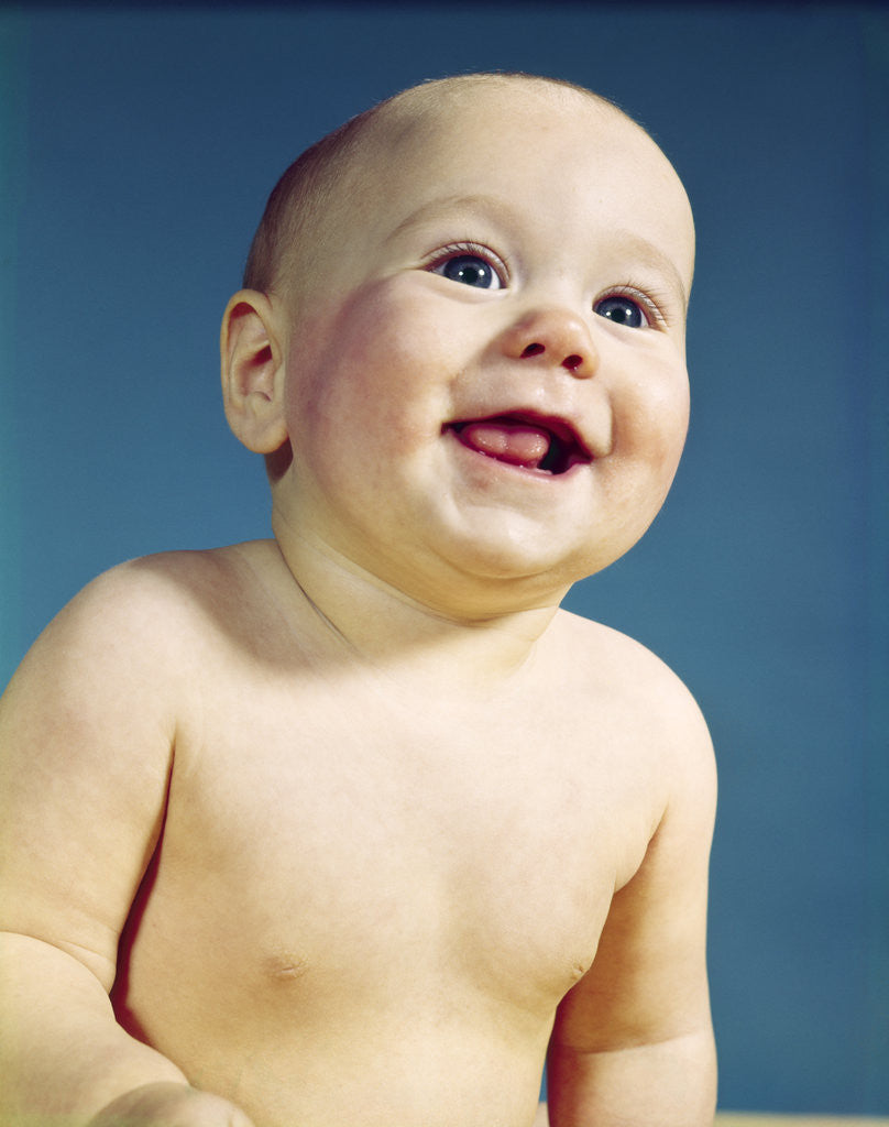 Detail of 1960s baby bald smiling portrait eager happy facial expression by Corbis