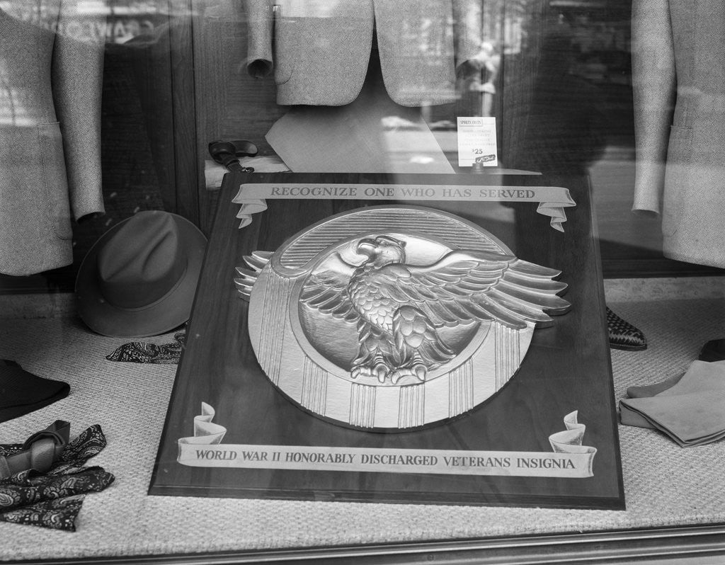 Detail of 1940s 1945 plaque of the war veterans honorable discharge button insignia in store window by Corbis