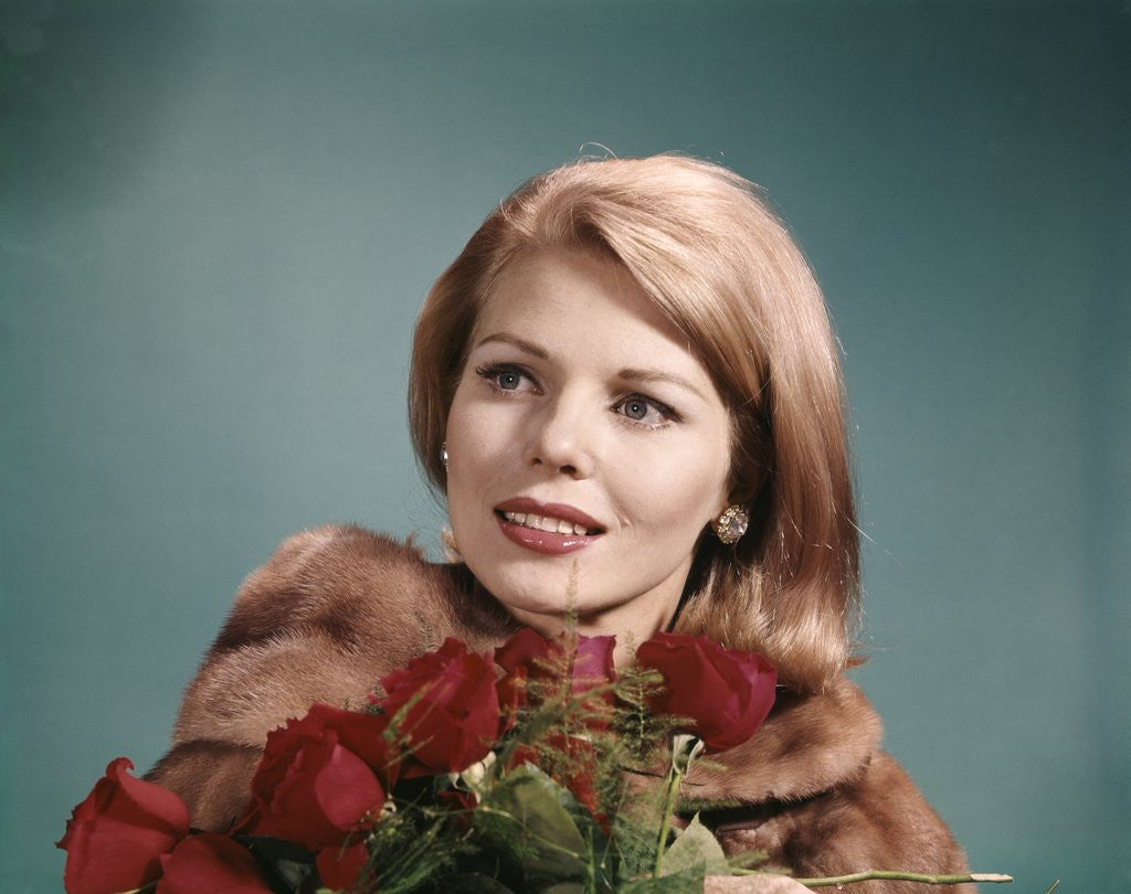 Detail of 1960s Blond Woman Wearing Fur Coat Holding Bunch Of Red Roses by Corbis