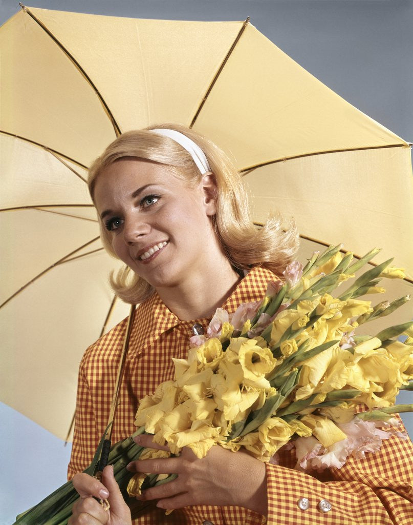 Detail of 1960s Smiling Blond Woman Umbrella Holding Bouquet Yellow Gladiolas by Corbis