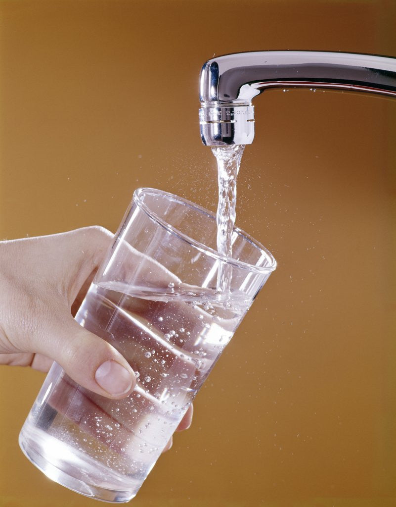 Detail of 1970s Hand Holding Glass Under Running Water Faucet by Corbis