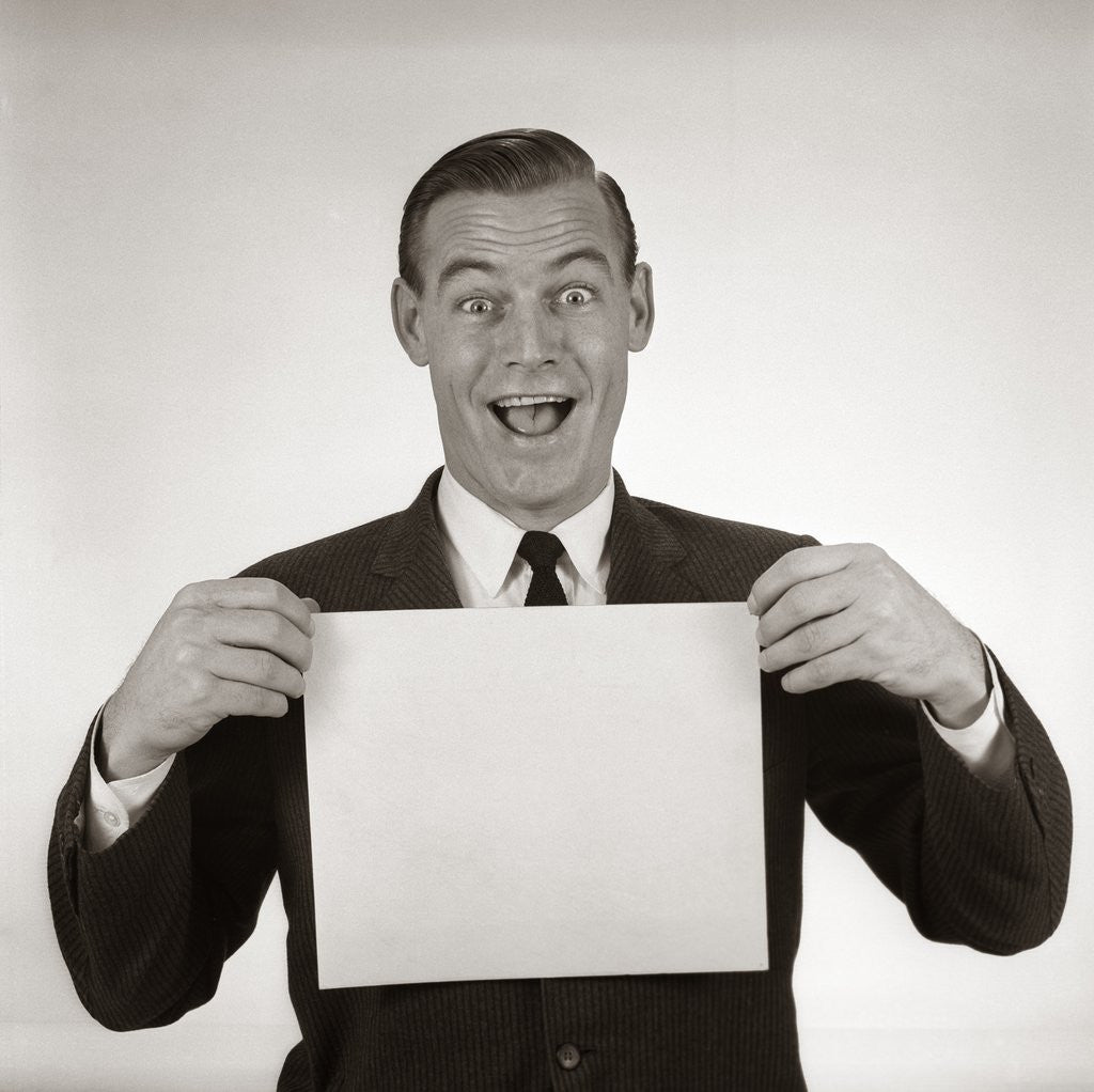 Detail of 1950s 1960s Excited Businessman Looking At Camera Holding Blank White Card by Corbis