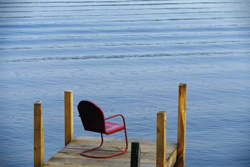 Detail of single Red Painter Metal Chair On End Of A Dock Lake George New York Usa by Corbis