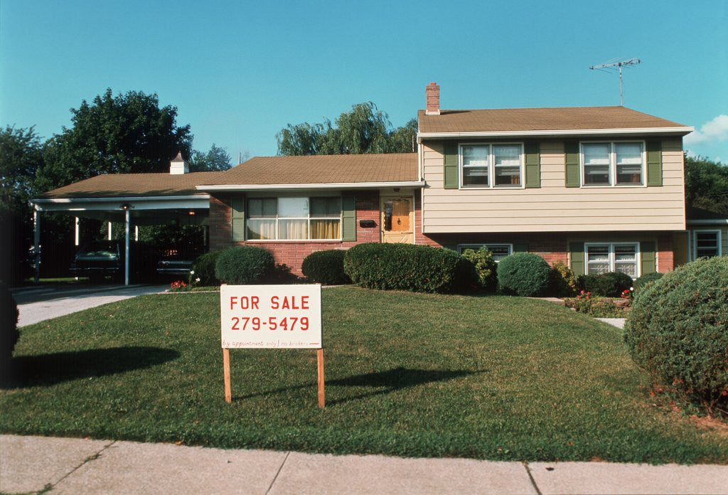 Detail of 1960s 1970s Split Level Suburban House With Two Cars In Carport Rooftop Tv Aerial For Sale Sign by Corbis