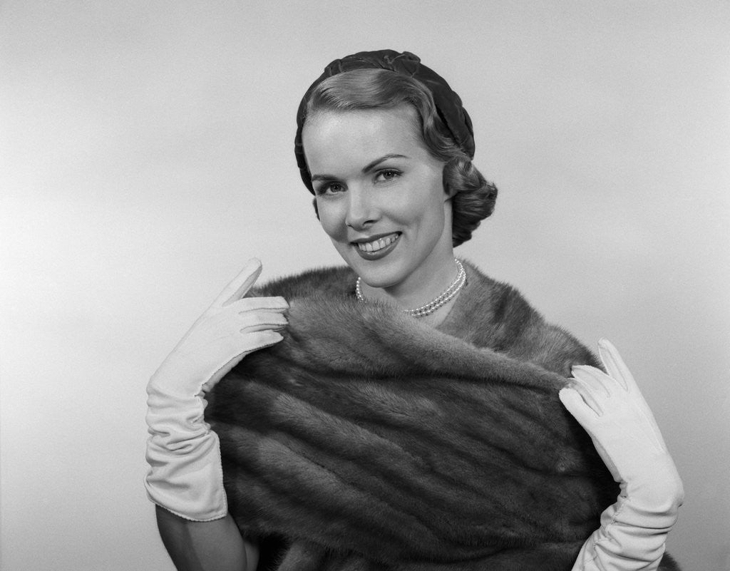 Detail of 1950s Portrait Glamorous Smiling Woman Wearing Mink Stole White Gloves Pearls And Hat Looking At Camera by Corbis